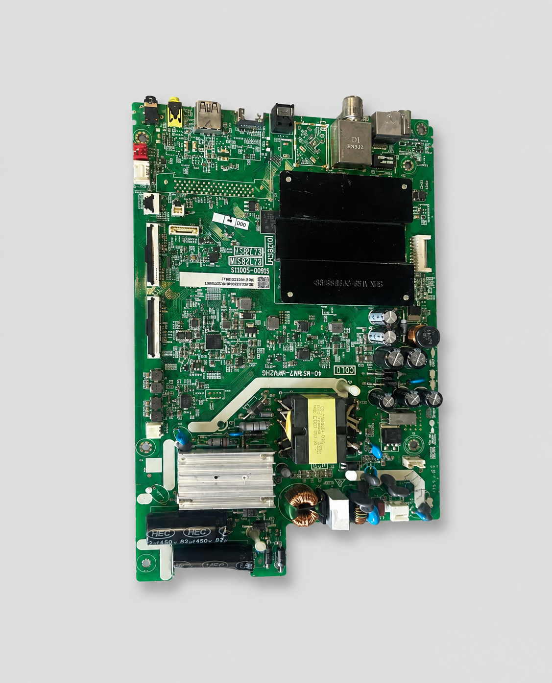 Green LED TV mainboard PCB with HDMI, USB, AV, RF input ports, power components, and integrated circuit mounted on a light gray background.