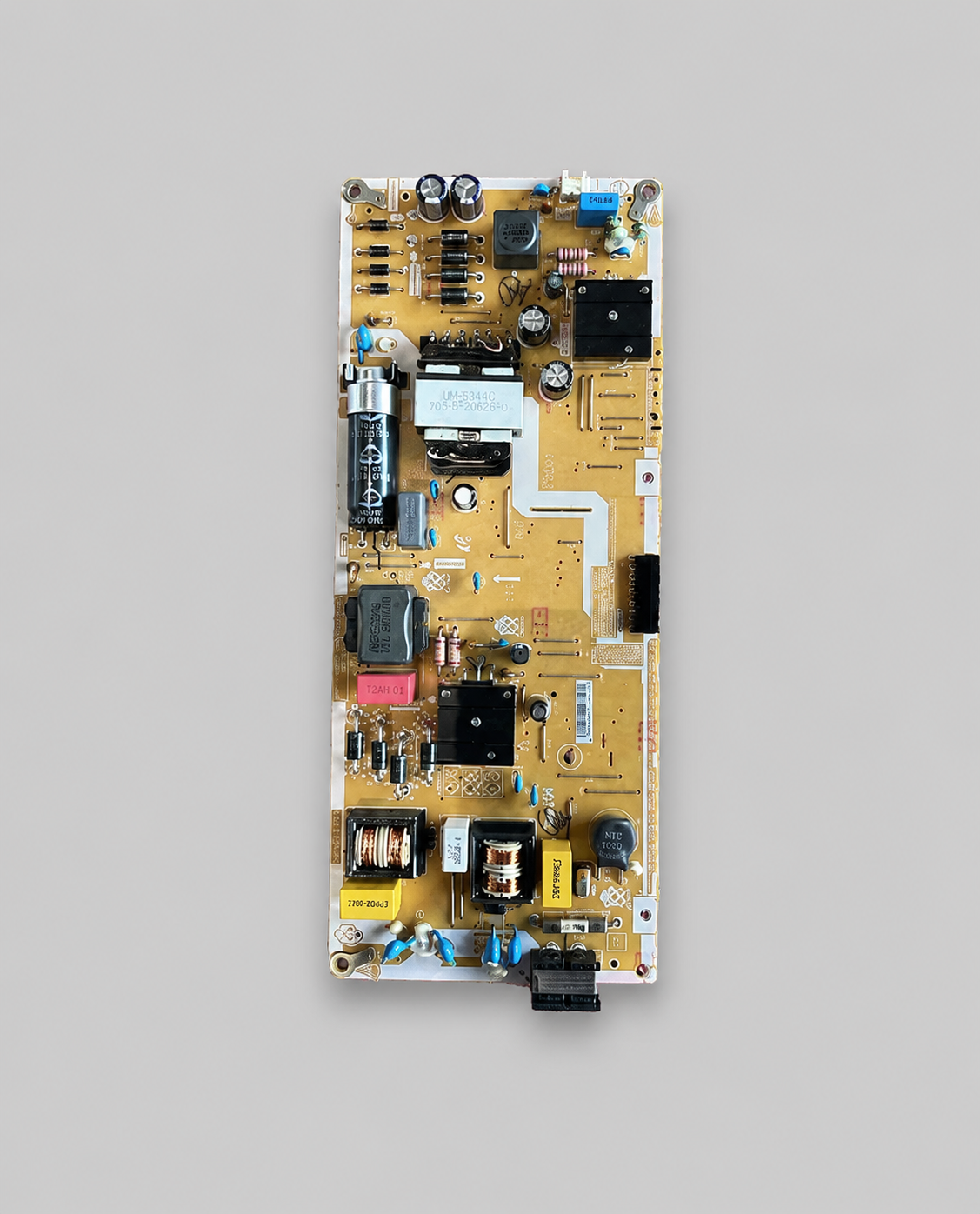 Power supply PCB board for LED Smart TV displayed on a clean light gray background with electronic components and connectors clearly visible.