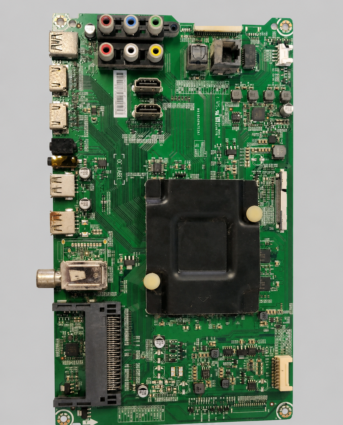 Green TV main motherboard (PCB) with HDMI, USB, AV, LAN, RF, and other input/output ports displayed on a clean light gray background.