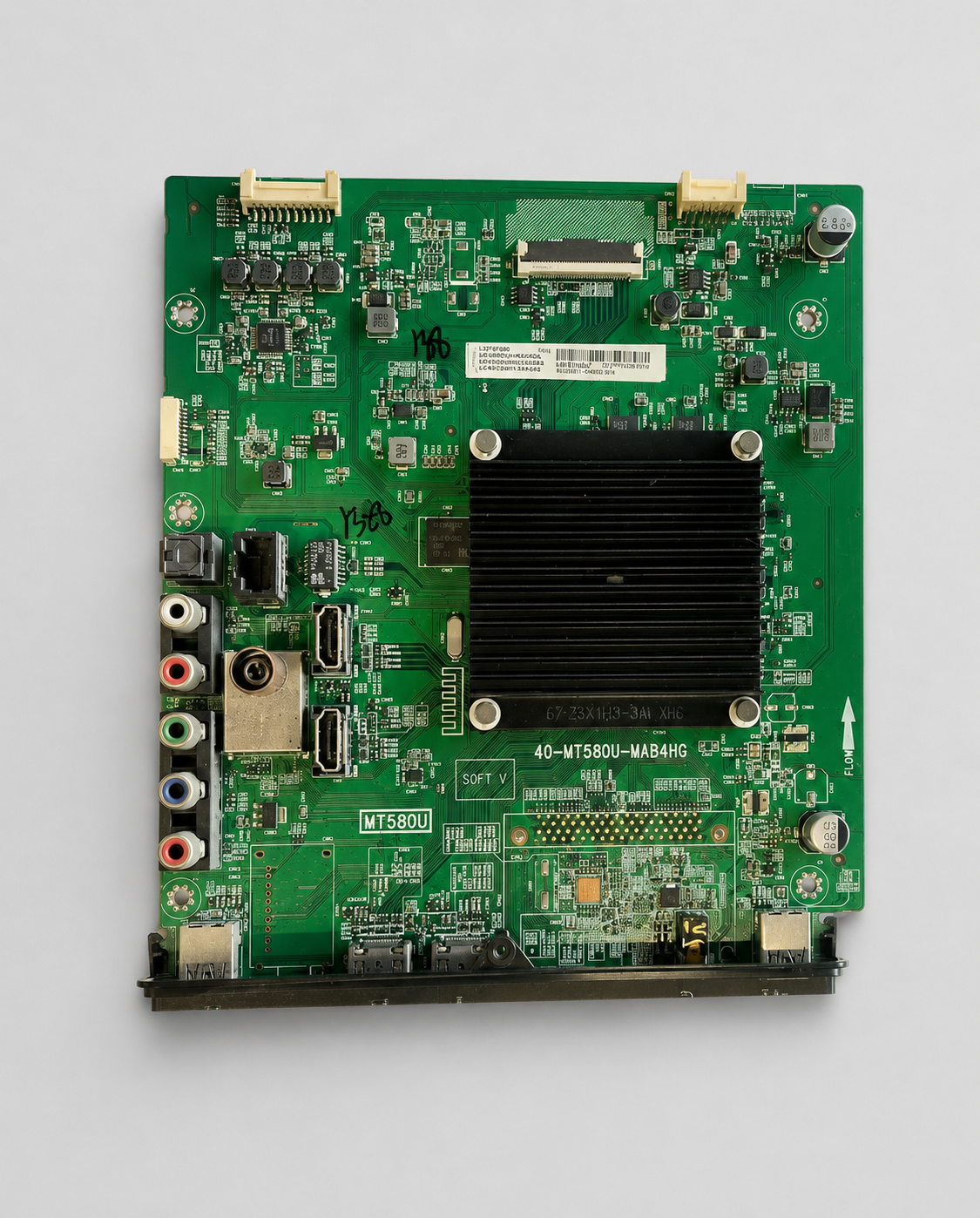 40-MT580U-MAB4HG LED TV main board with black heatsink and multiple HDMI, AV, USB, and antenna ports on a light gray background.
